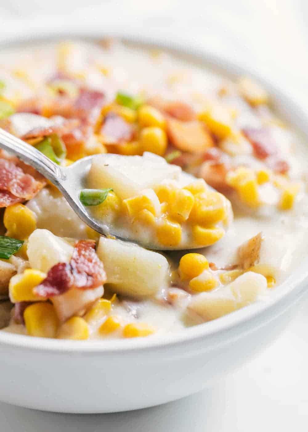 Bowl of corn chowder with spoon.