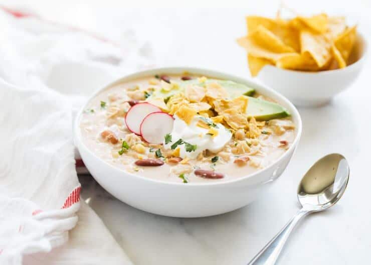 White Chicken Chili - A creamy and delicious white chicken chili recipe that's perfect for a chilly day! Takes just 5 minutes of prep and is great for busy weeknights. Add all your favorite toppings and dig in! white chicken chili