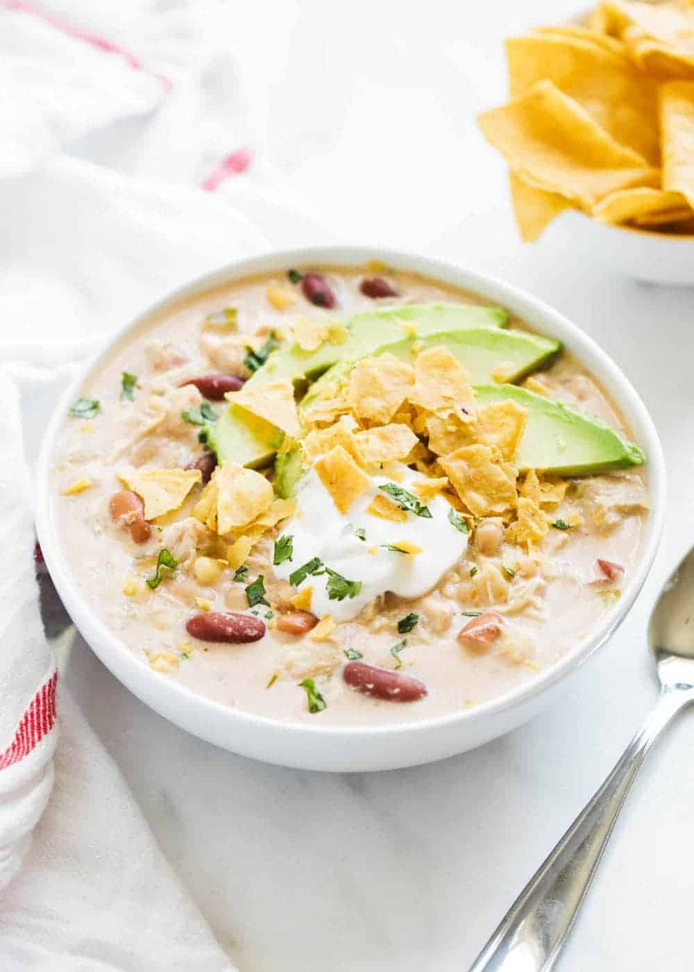 bowl of white chicken chili with toppings 