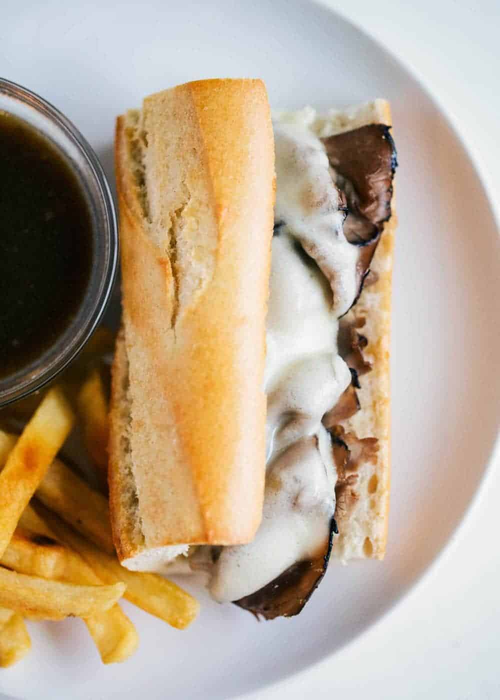 French dip sandwich on a white plate.