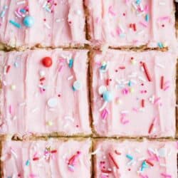 sugar cookie bars with pink buttercream and sprinkles