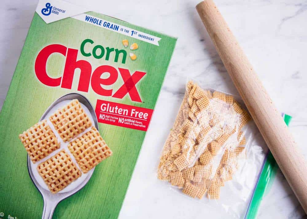 Crushing Chex cereal with a rolling pin.