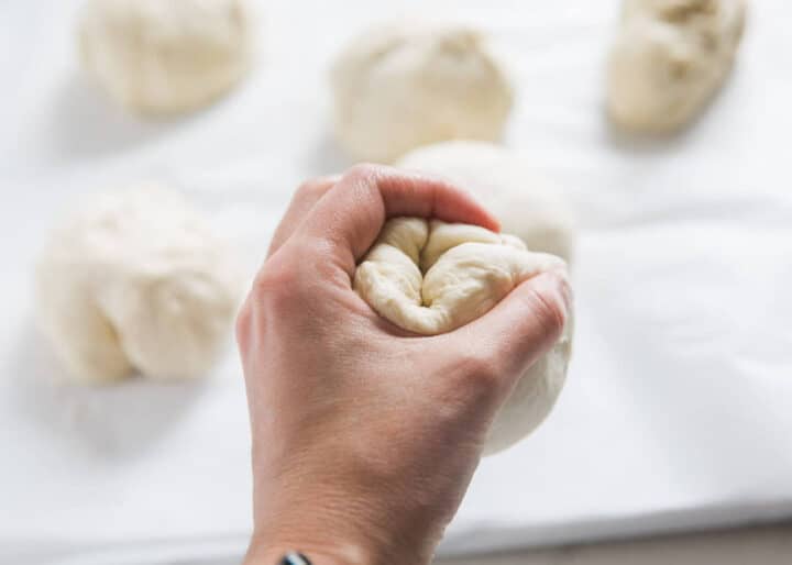 forming dough into a ball with hands 