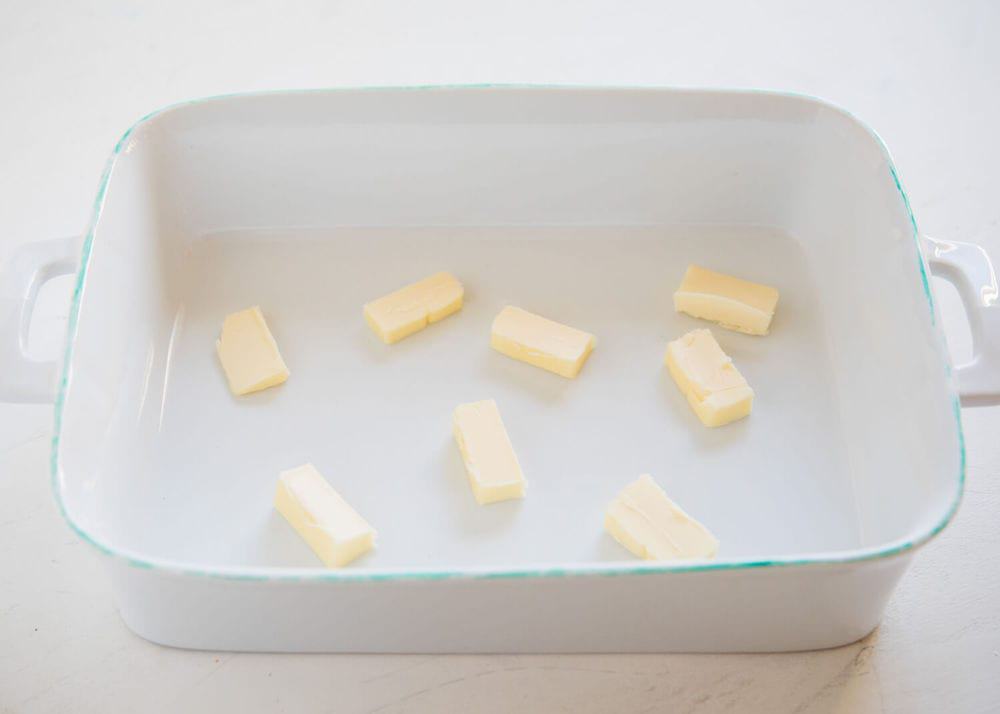 Sliced butter in a baking dish.