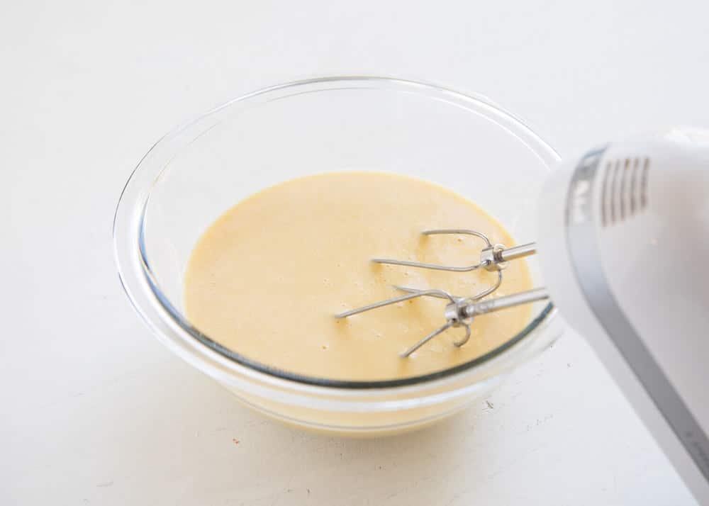 Mixing german pancake batter with electric mixer.