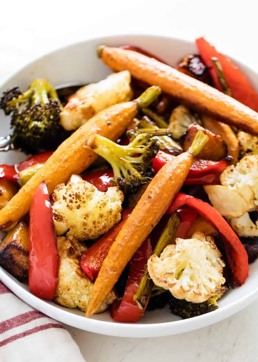Baked vegetables in a white bowl.