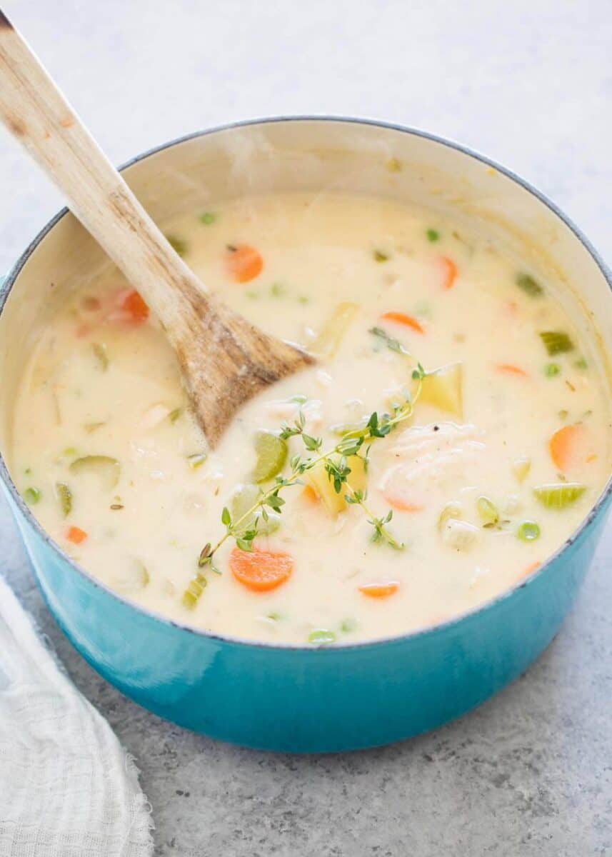 pot pie soup in large pot with wooden spoon