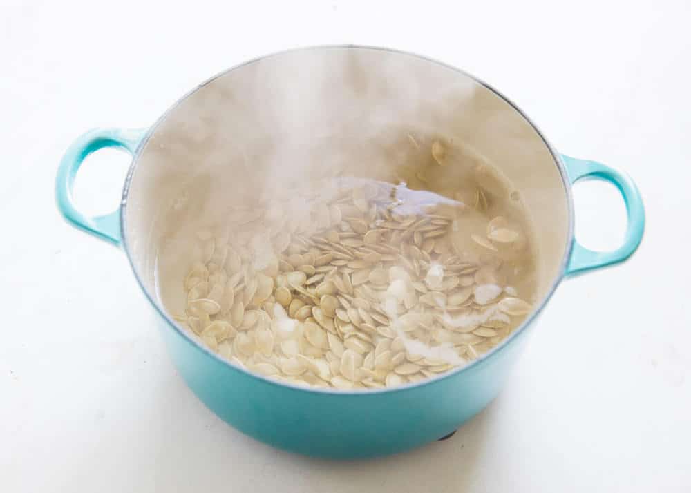 Boiling pumpkin seeds in water.