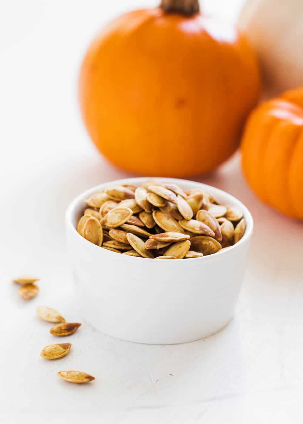 Roasted pumpkin seeds in bowl.