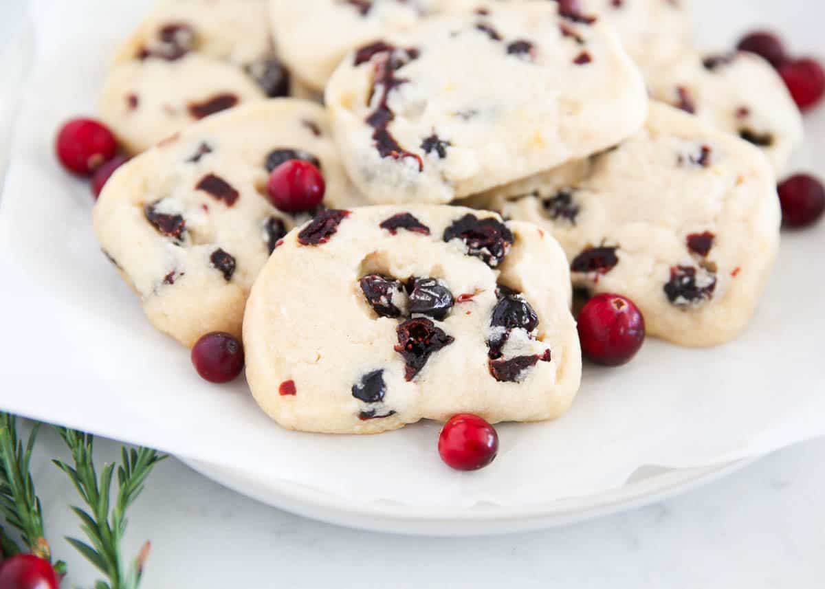 Cranberry orange cookies on white plate.