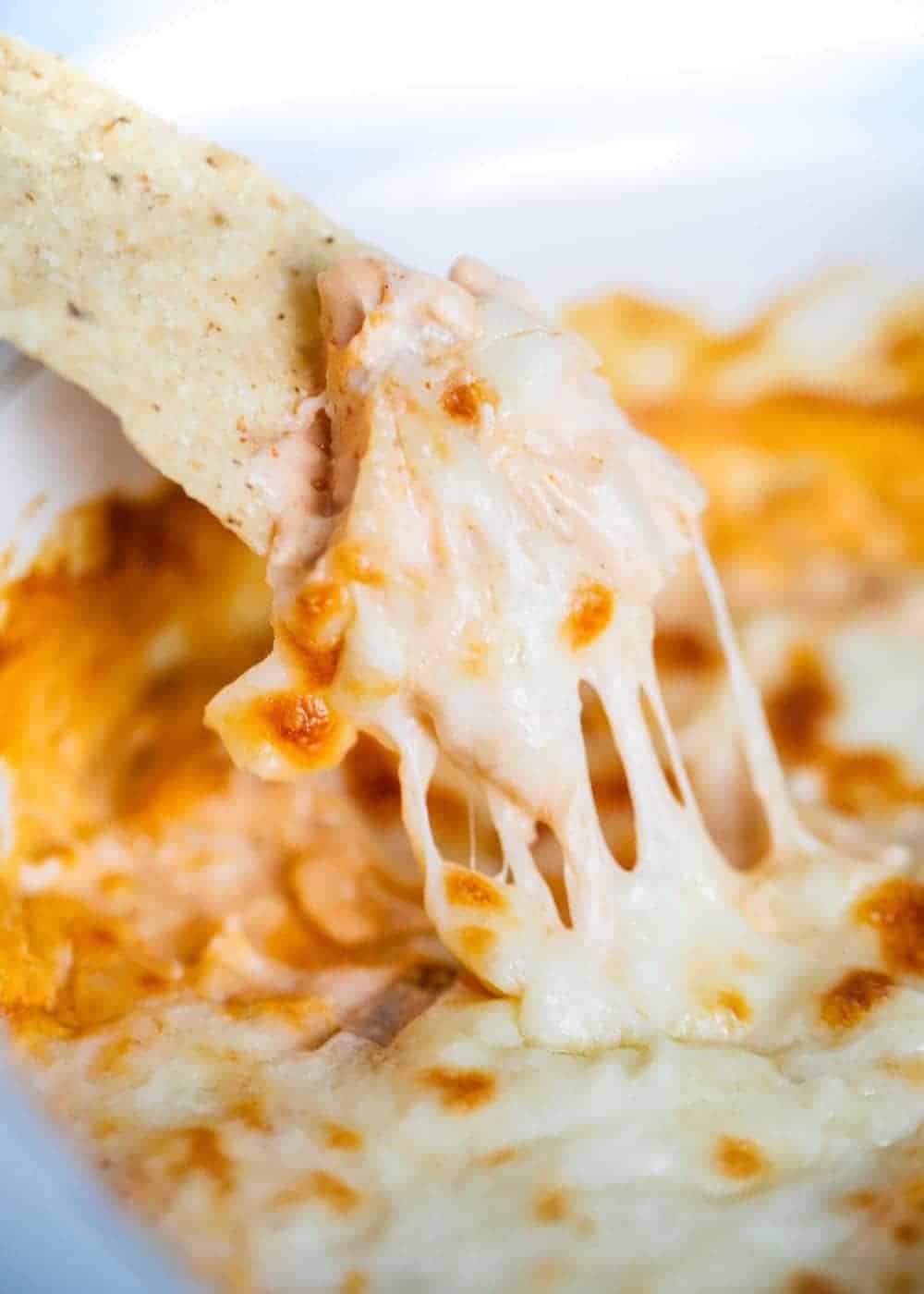 Dipping a tortilla chip into buffalo chicken dip.