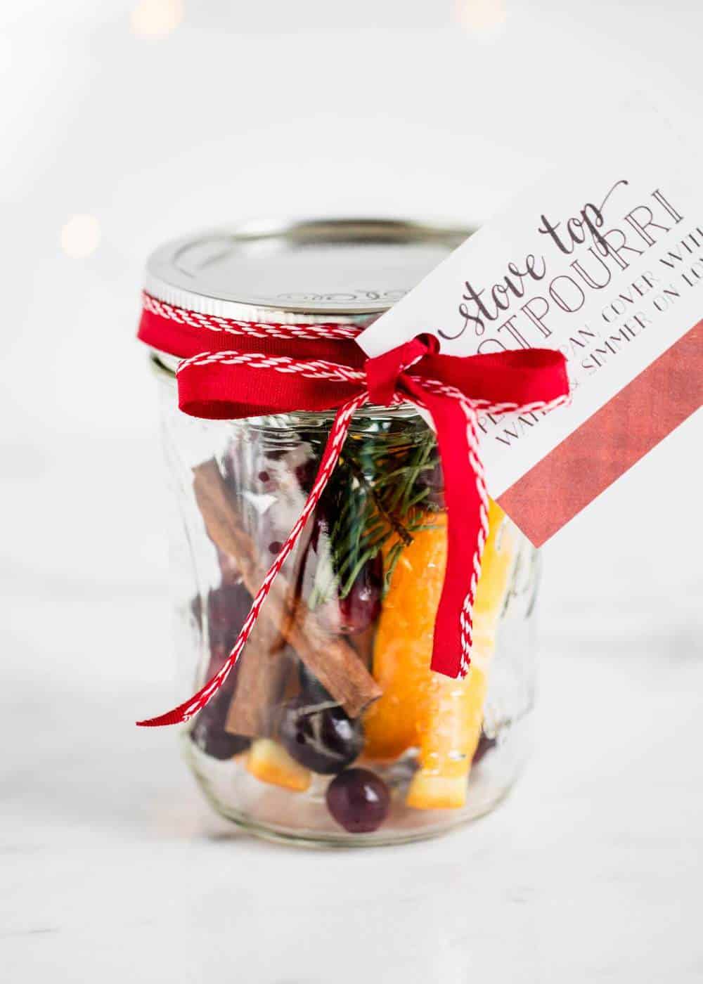 Christmas potpourri in jar with ribbon and tag.