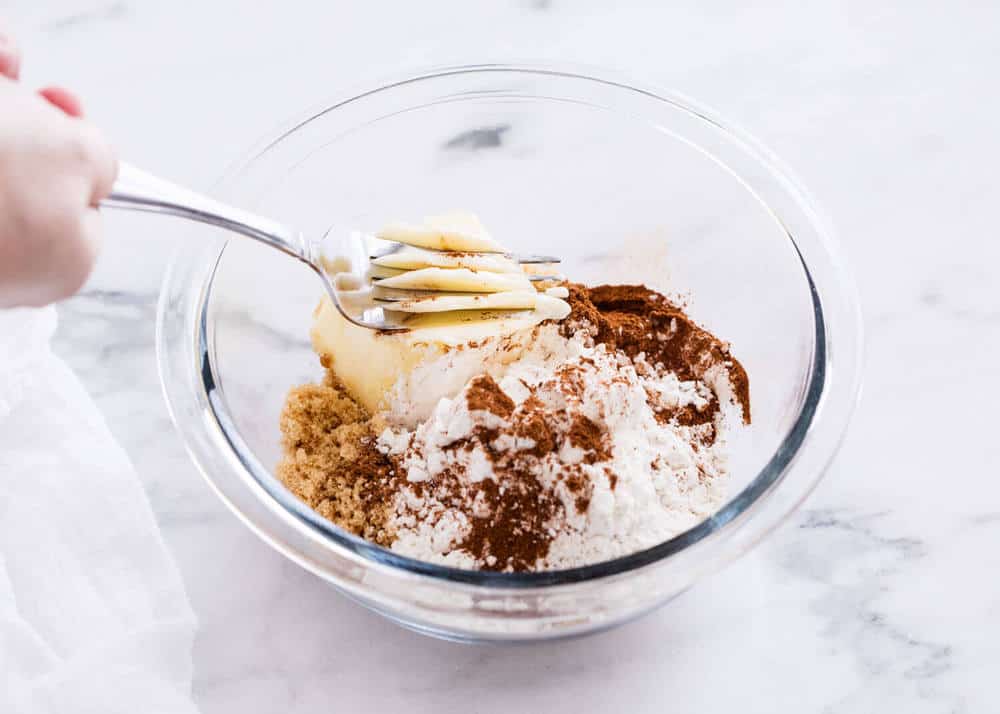 Mixing crumb topping in bowl.
