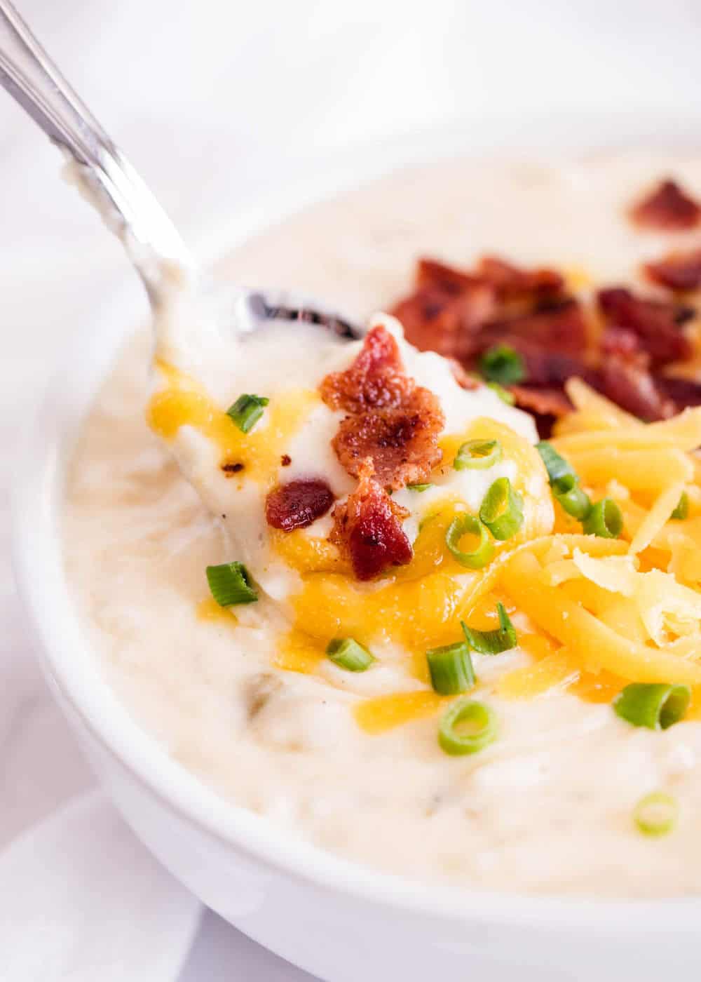 bowl of slow cooker potato soup with a spoon 