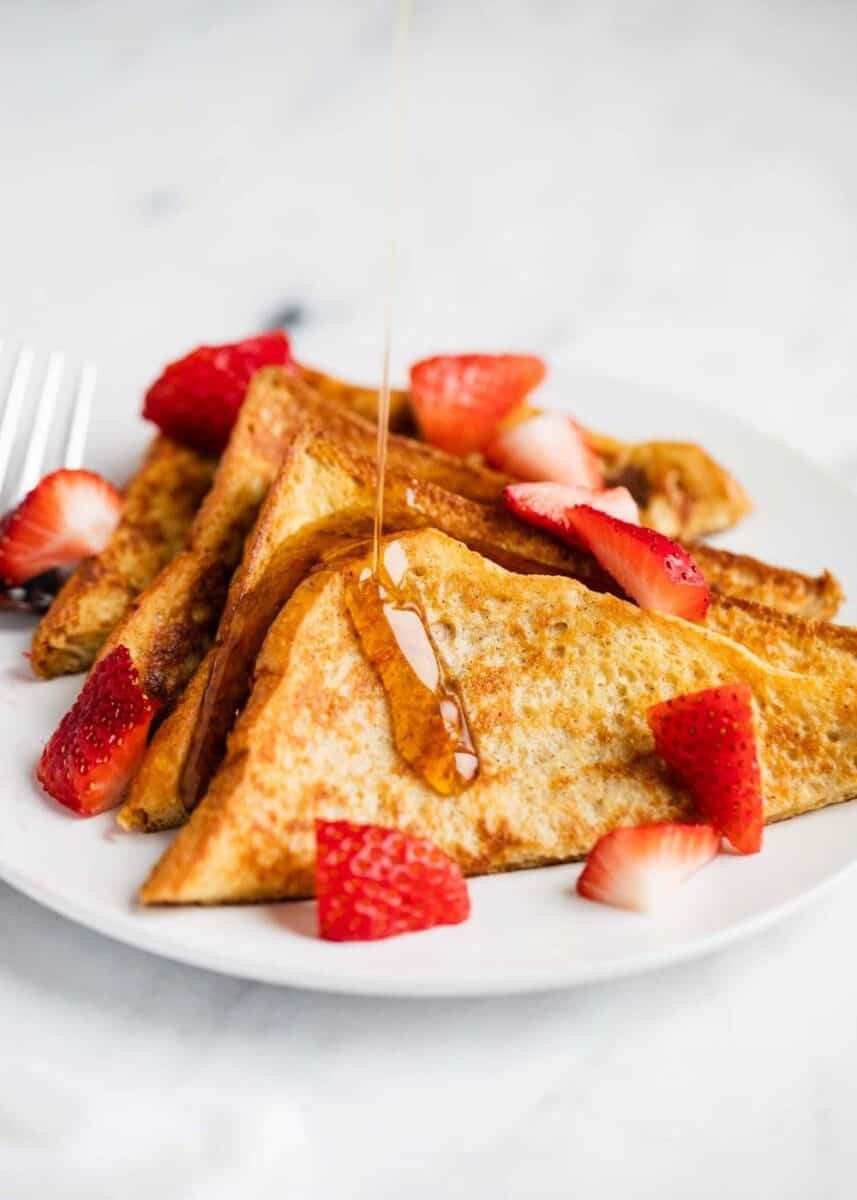 pouring syrup over french toast 