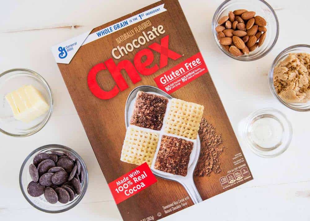 Chex mix box with glass bowls filled with ingredients. 