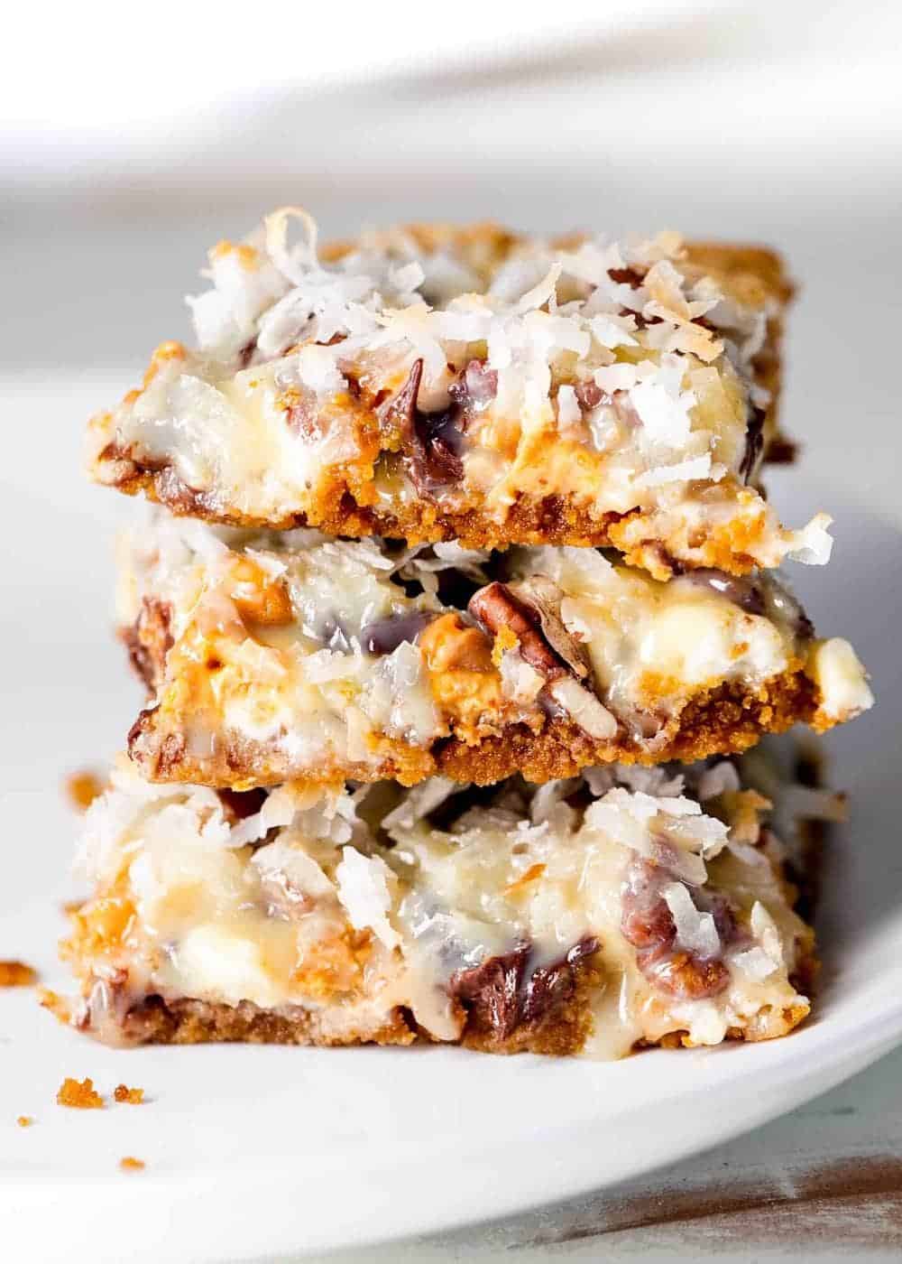 Stack of 7 layer magic bars on a plate. 