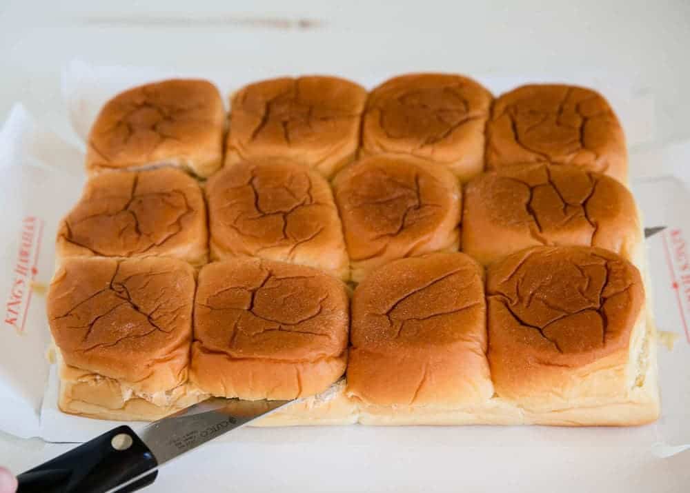 Slicing Hawaiian rolls.