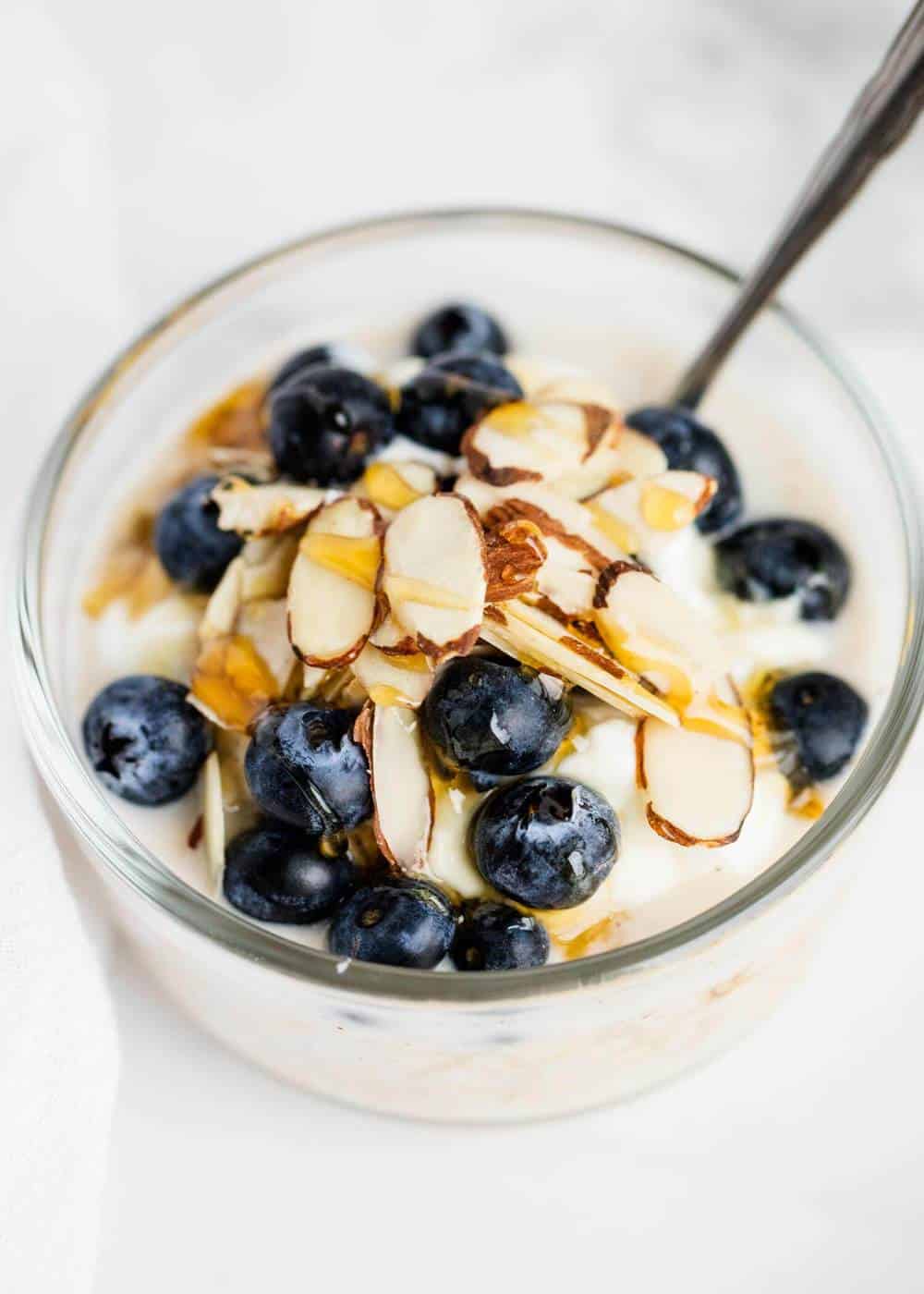 Healthy overnight oats topped with blueberries, almonds and honey.