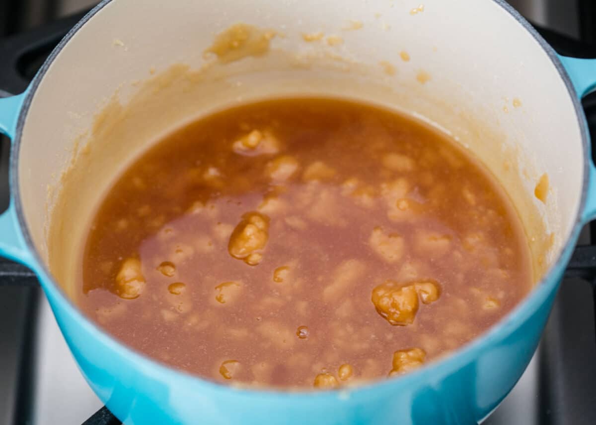 cooking caramel sauce in blue pot