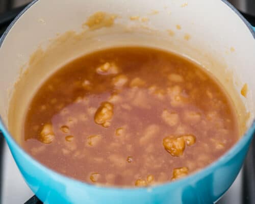 cooking caramel sauce in blue pot