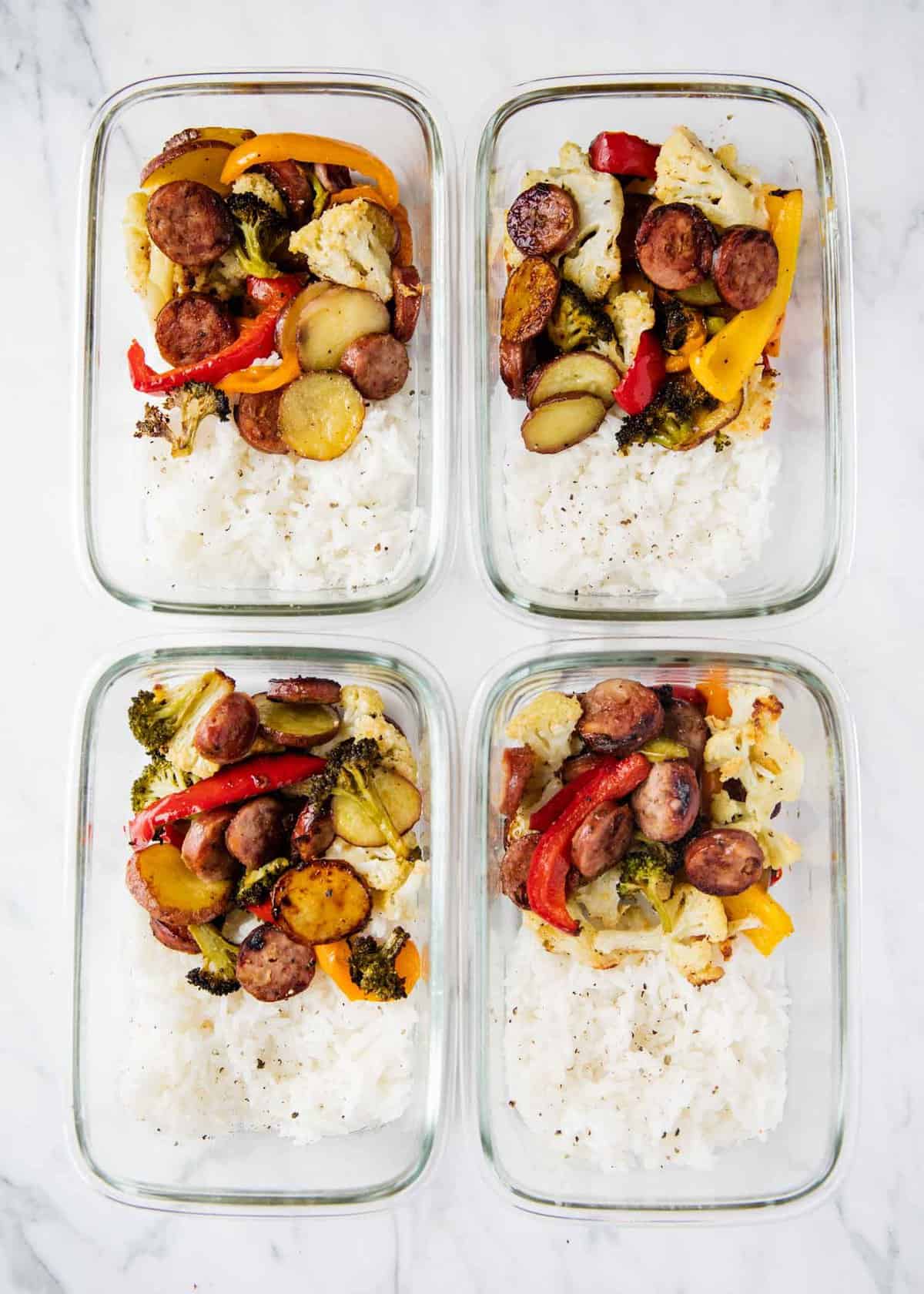 Sausage and veggies in meal prep containers with rice.