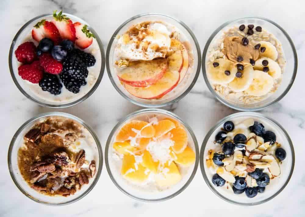 6 bowls of different overnight oats combinations.