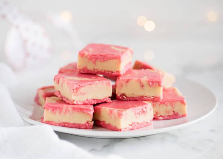 stack of peanut butter and jelly fudge on a white plate 