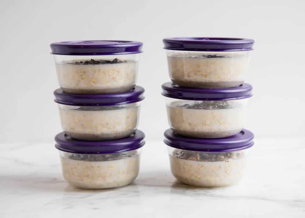 Stack of overnight oats in meal prep containers.