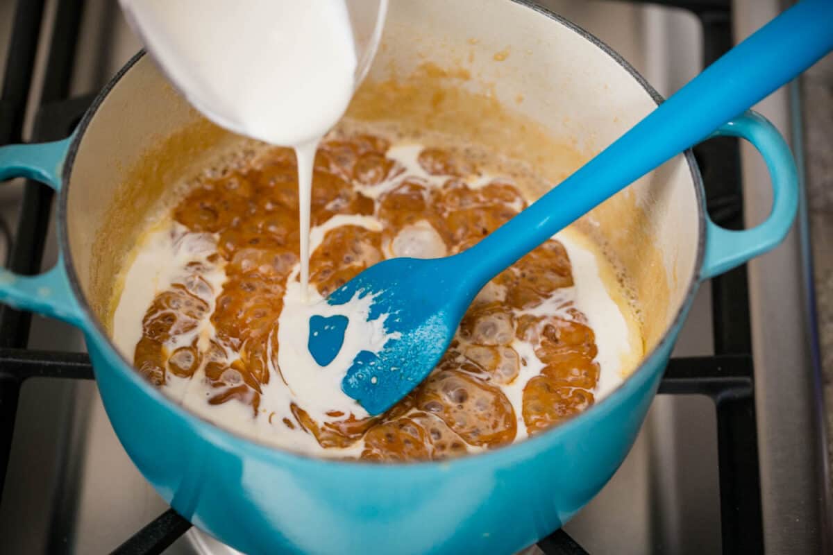 pouring cream into caramel sauce