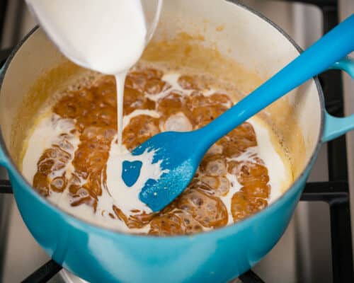 pouring cream into caramel sauce