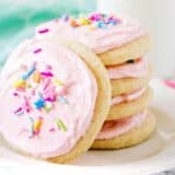 stacked sugar cookies with pink frosting and sprinkles