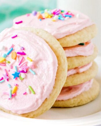 stacked sugar cookies with pink frosting and sprinkles
