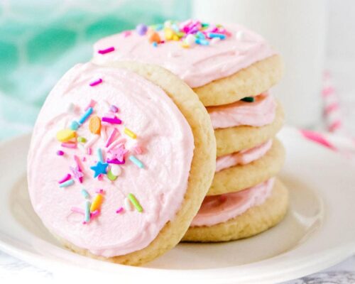stacked sugar cookies with pink frosting and sprinkles