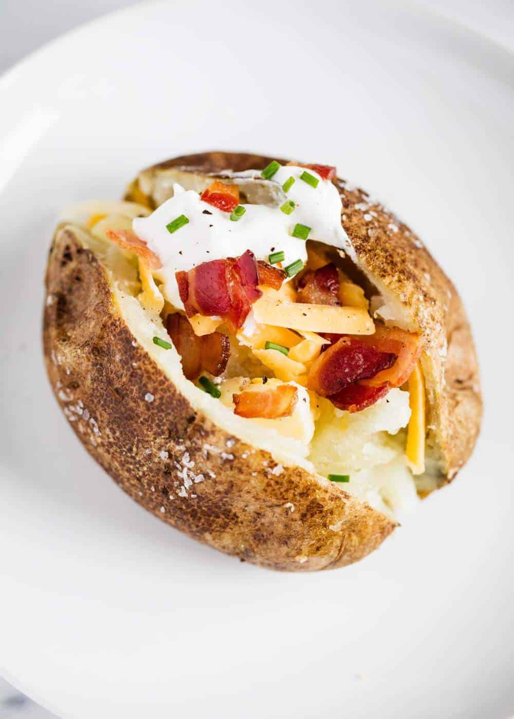 Loaded baked potato with cheese, sour cream, bacon and chives.