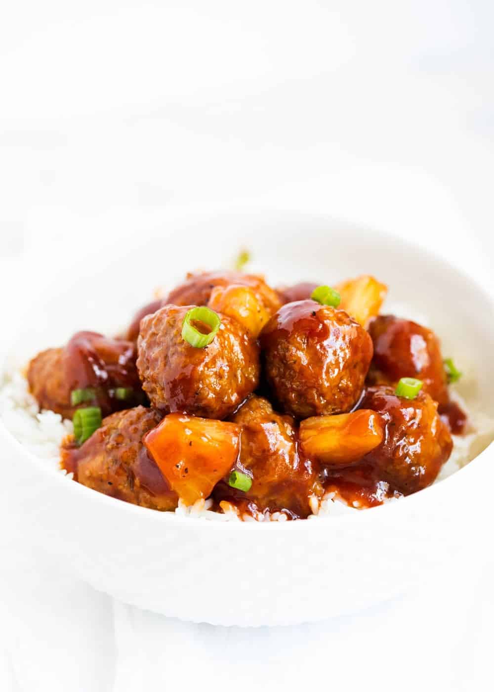 Hawaiian meatballs in a white bowl. 