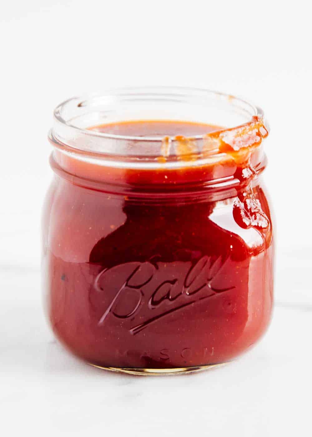 Homemade bbq sauce in glass jar.