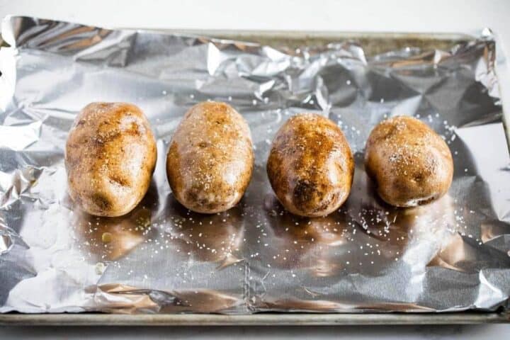 baked potatoes on a baking sheet lined with foil
