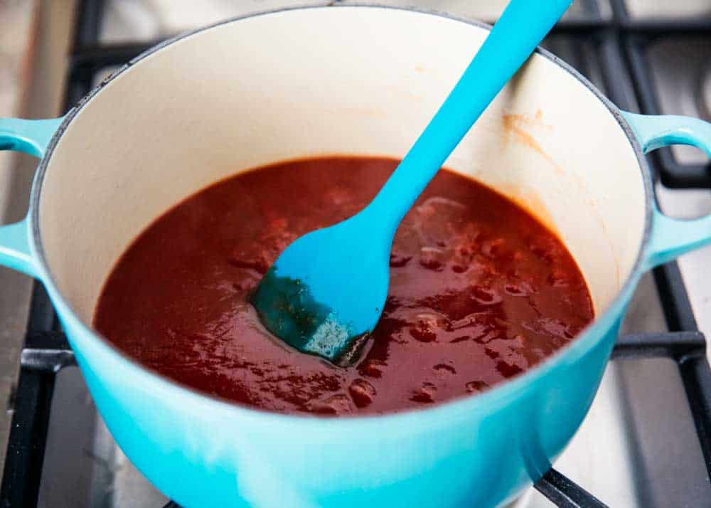 Stirring bbq sauce in pot.