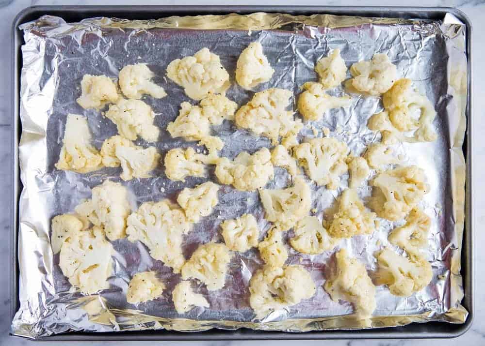 parmesan roasted cauliflower on an aluminum lined baking sheet 