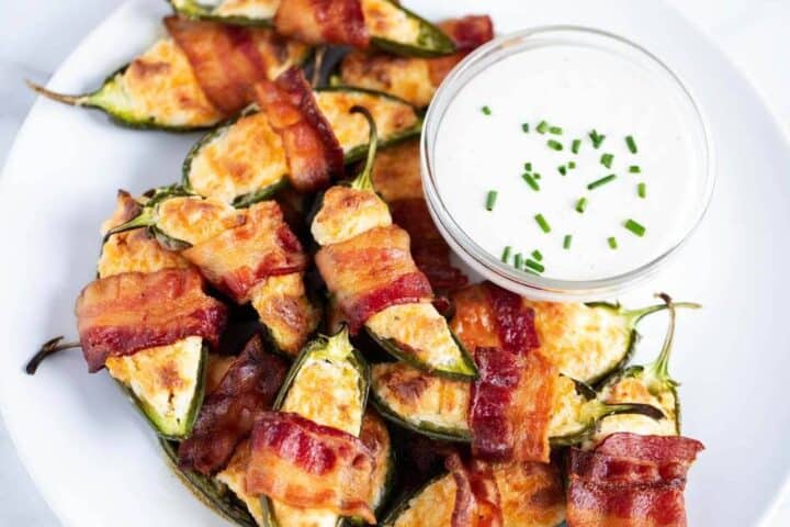 jalapeno poppers with a small bowl of ranch for dipping 
