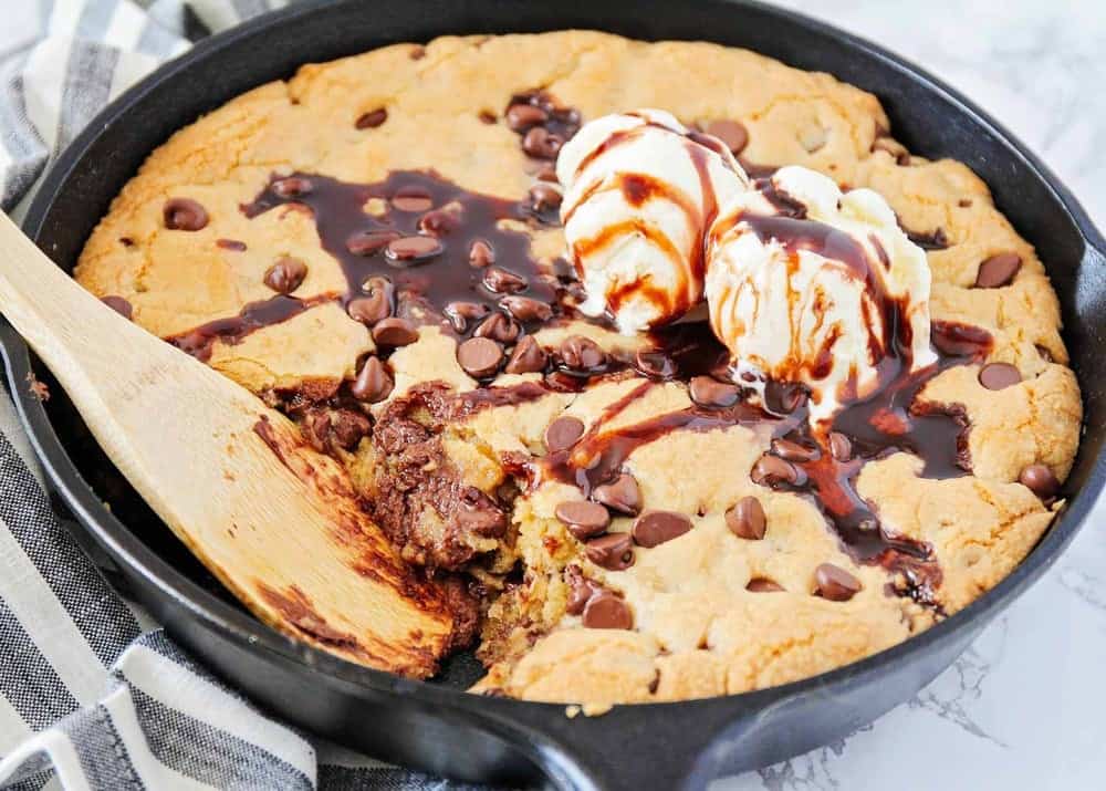 Chocolate chip cookie in a cast iron skillet.