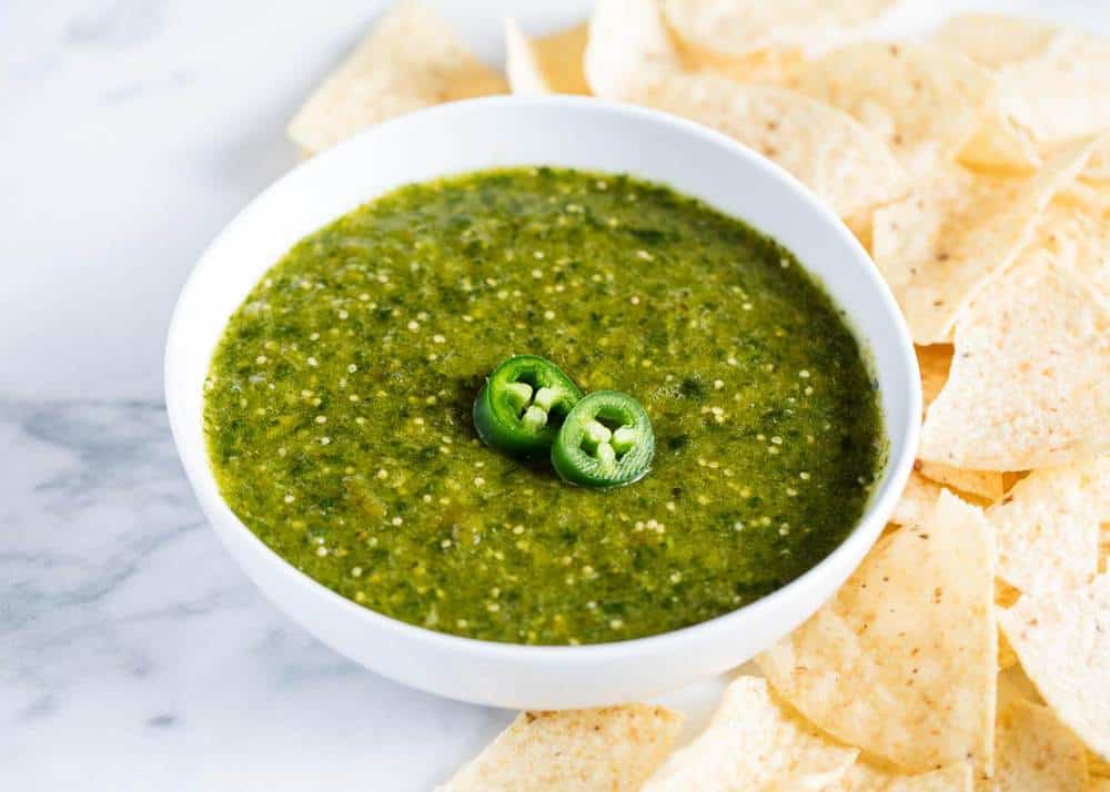 Salsa verde in bowl with tortilla chips.