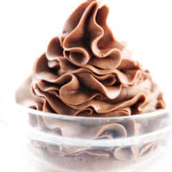 Chocolate buttercream piped in a glass bowl.