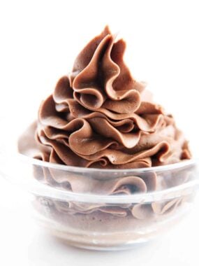 Chocolate buttercream piped in a glass bowl.