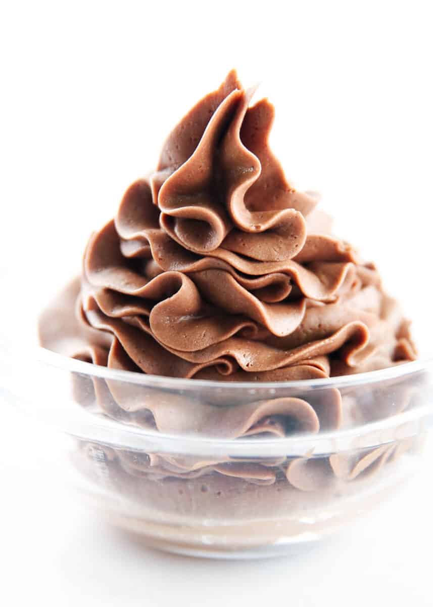 Chocolate buttercream piped in a glass bowl.