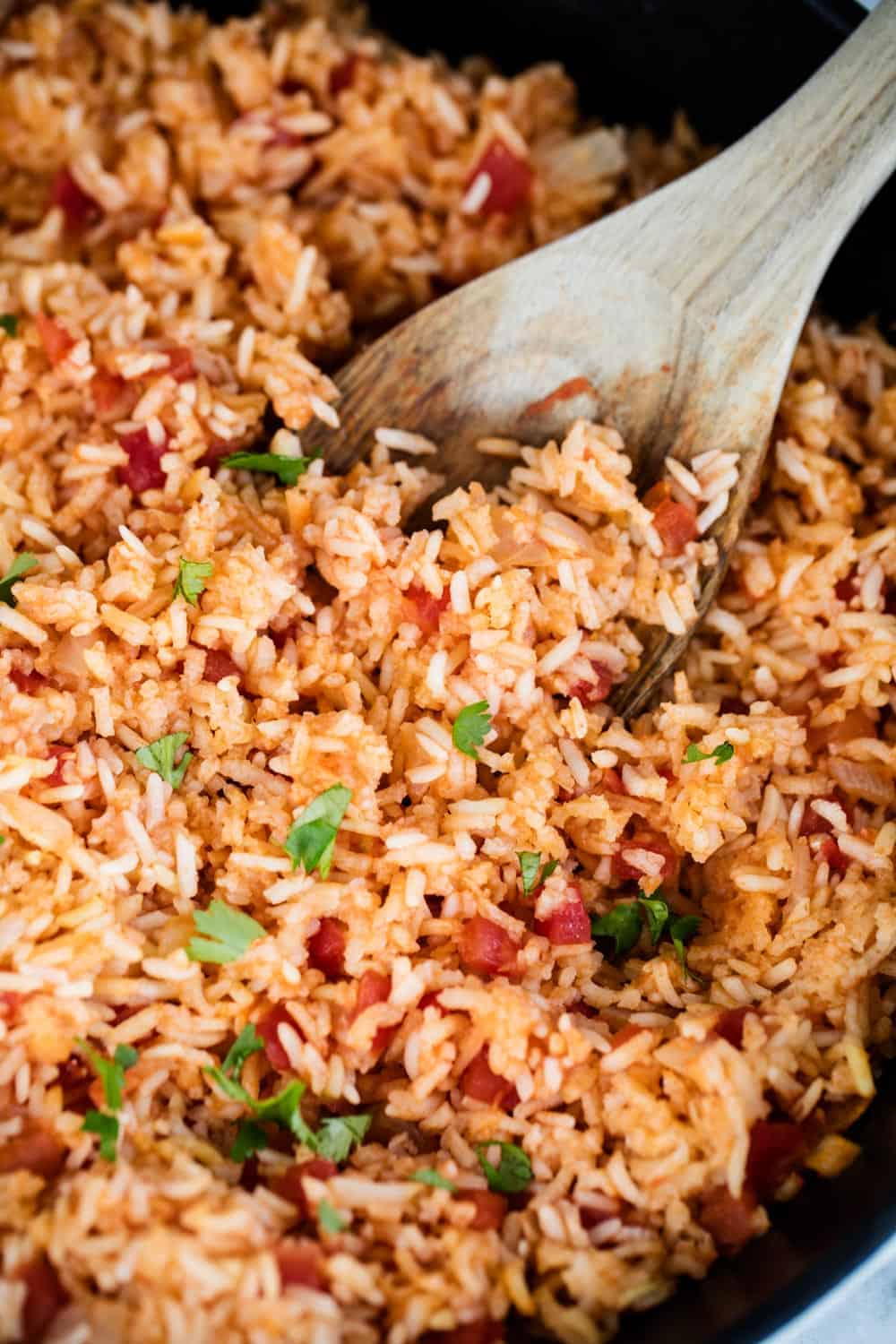Mexican rice with wooden spoon.