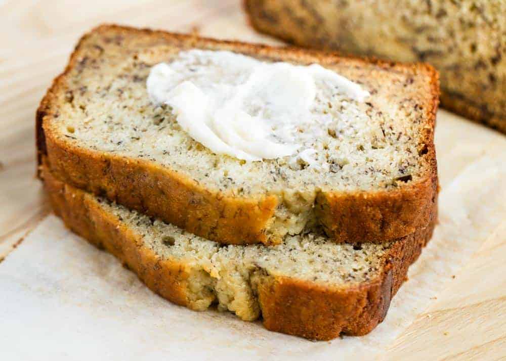 Piece of banana bread with butter on top.