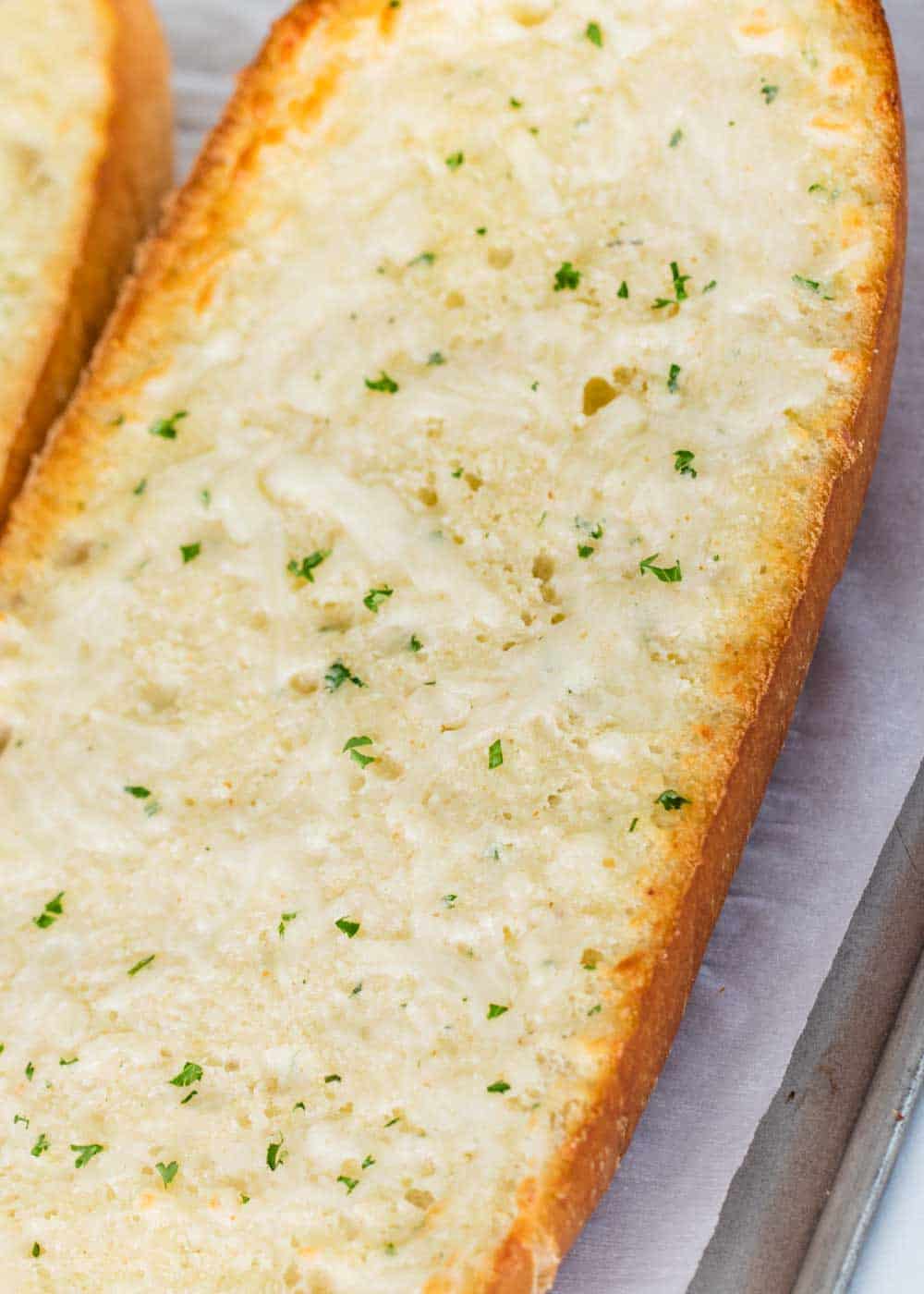 Close up of cheesy garlic bread.