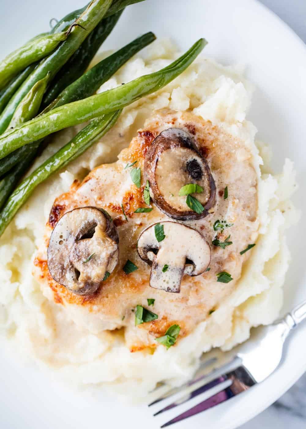Chicken marsala with mashed potatoes and green beans.